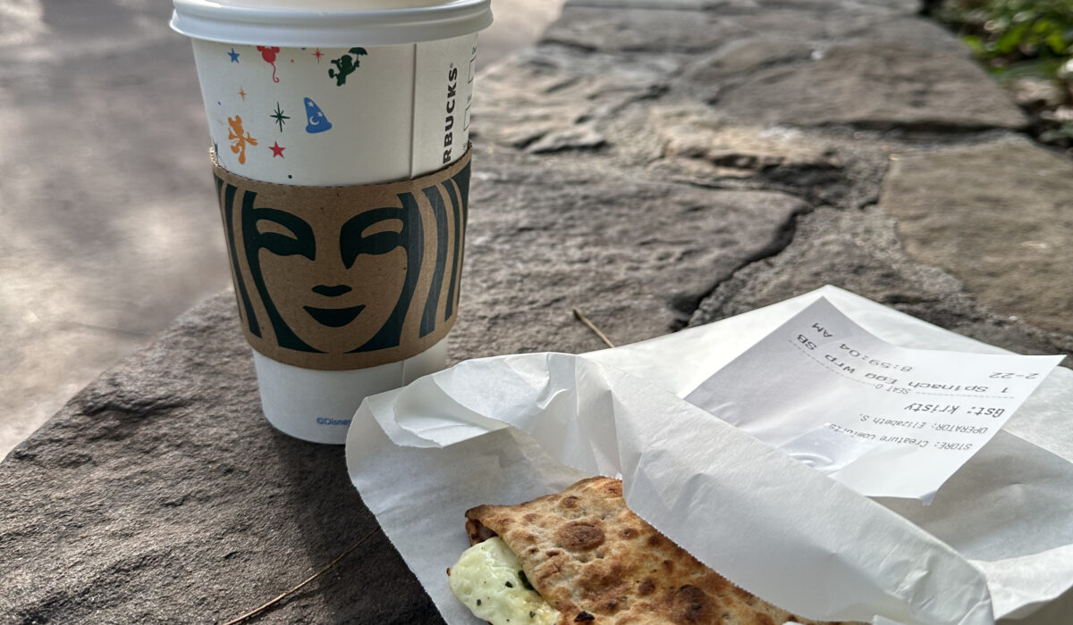 Spinach Feta Egg Wrap and Coffee sitting on ledge at Disney's Animal Kingdom