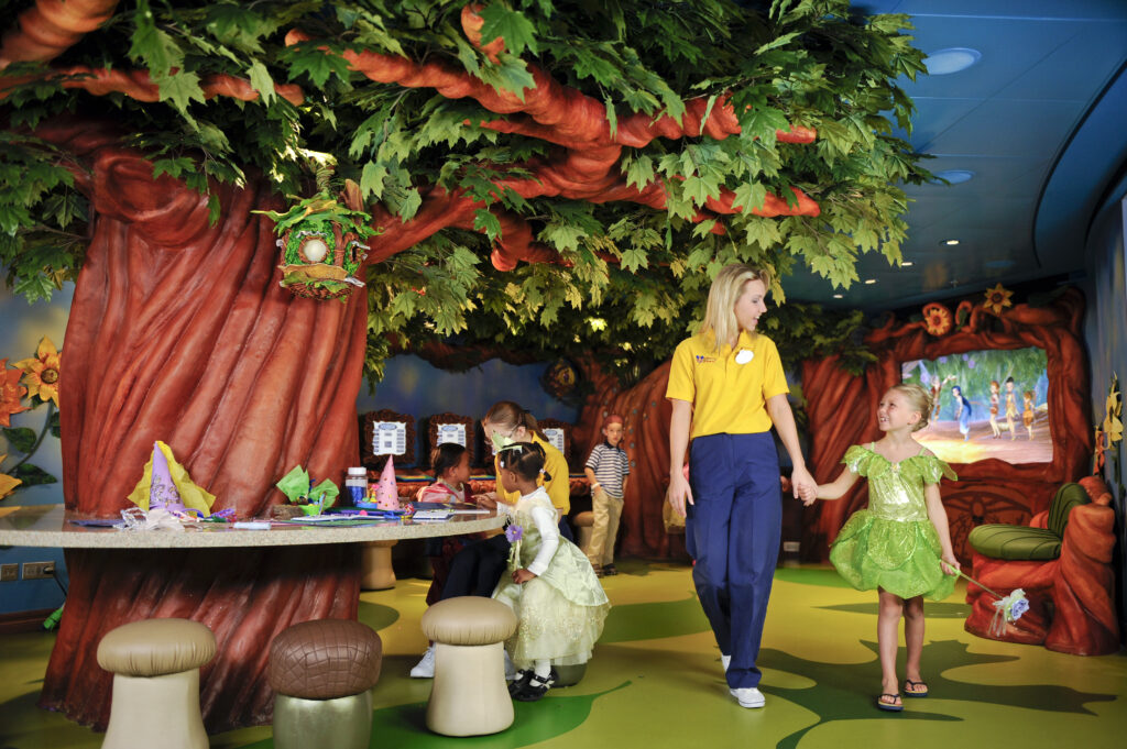 Cast member and little girl walking in Kids Club on Disney Cruise