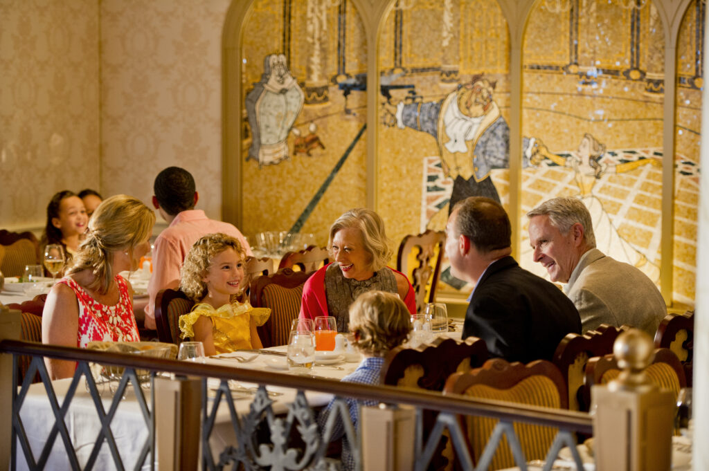 Grandparents and kids dining at Royal Court dinner on DCL Fantasy