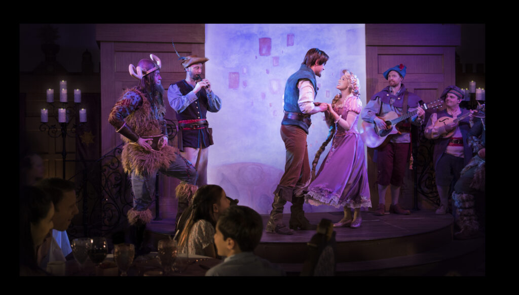 characters performing on stage during Rapunzel's Royal Table on the Disney Magic