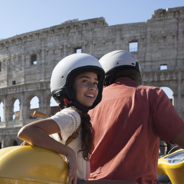 girl wearing helmet on bike with Rome in background