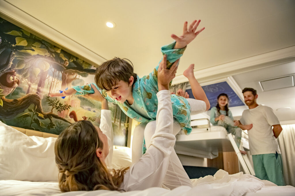 Mom playing with son in stateroom on Disney Wish