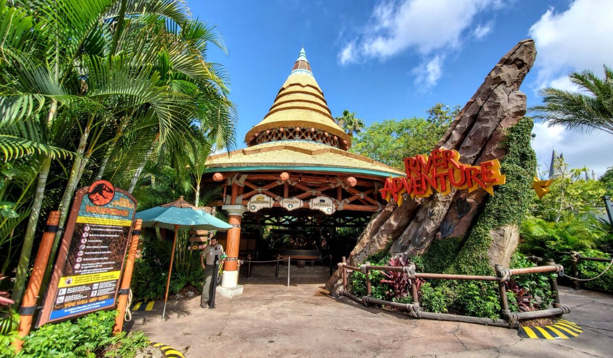 Entrance to Jurassic Park River Adventure in Universal Orlando Islands of Aventure with Team member ready to greet park visitors