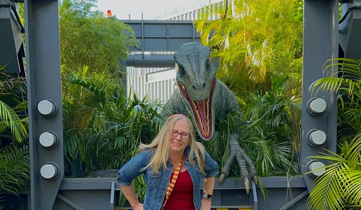 Woman getting scared by the velociraptor Blue during character meet at the Raptor Encounter in Universal Islands of Adventure in Orlando