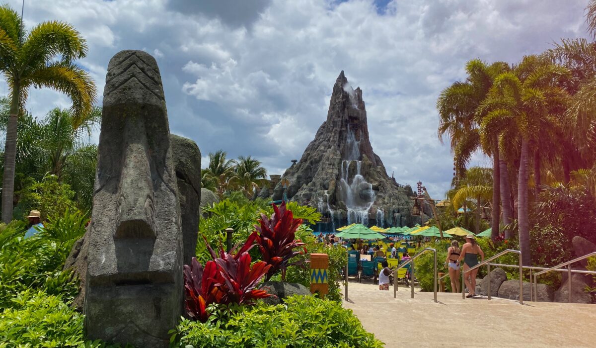 lush tropical entrance to pool area of Universal's Volcano Bay with Krakatau Volcano in background