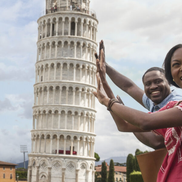 family holding up tower of pisa