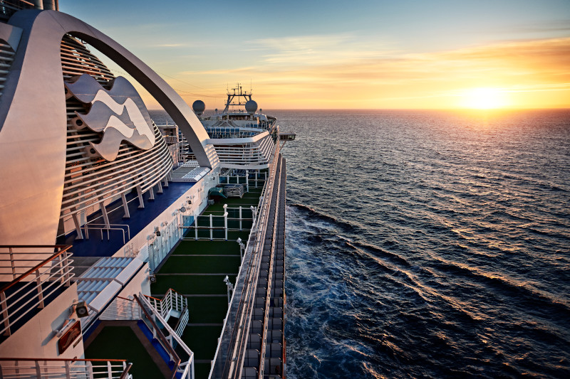 Princess cruise ship sailing on ocean at sunset